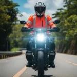 Un motociclista con equipo de alta visibilidad y luces encendidas en una carretera de Honduras.